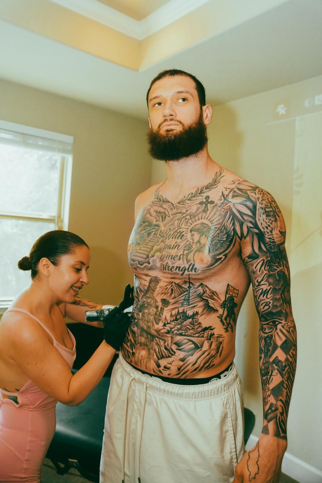 Chest tattoo with text and detailed artwork