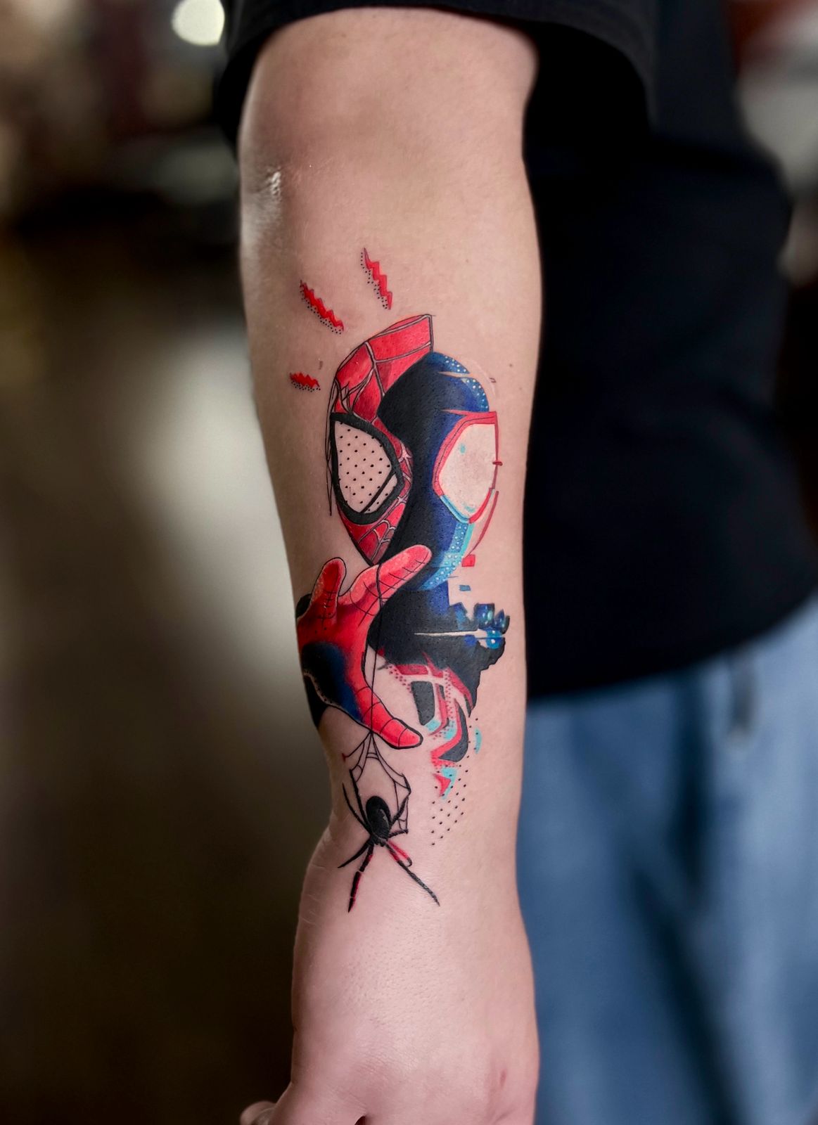 Spider-Man themed tattoo with split design