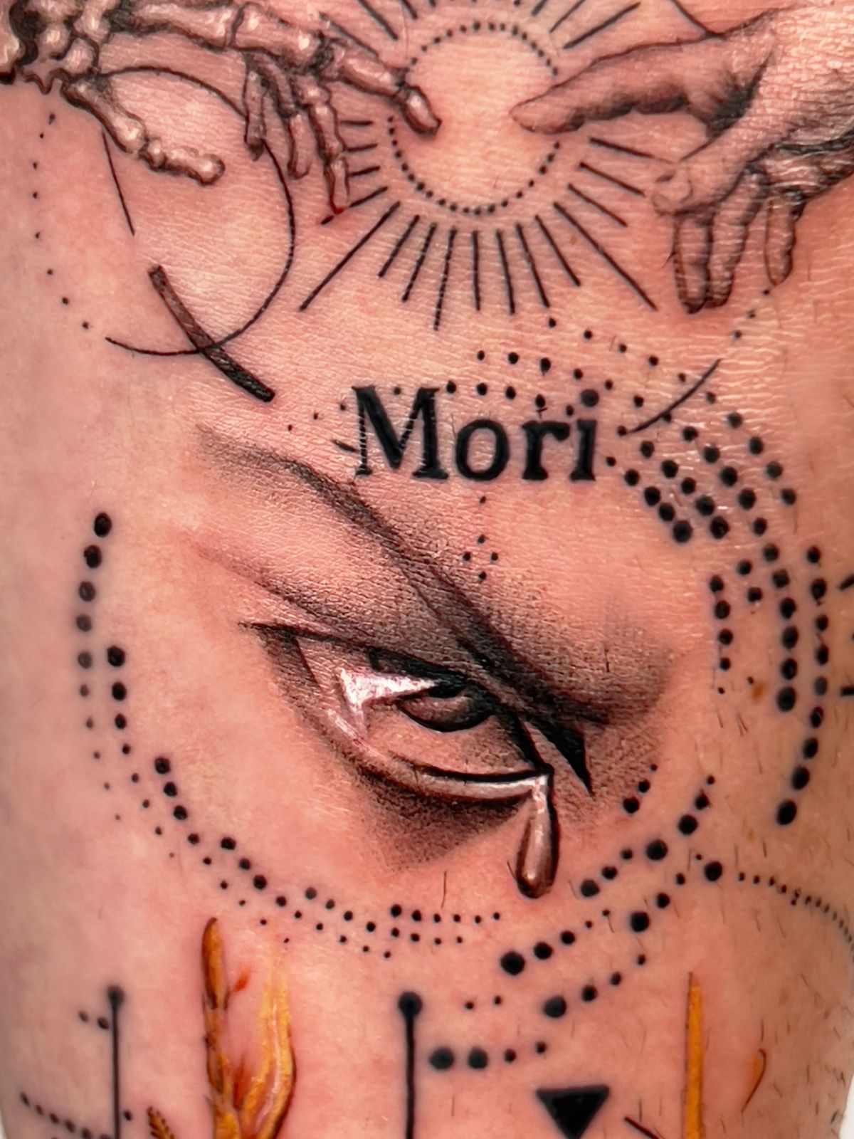 Artistic eye tattoo with Mori text and dotwork
